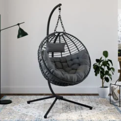 Fauteuil rond suspendu ajouré effet rotin gris avec coussin gris